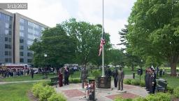 Wide shot of Police Memorial Ceremony with Flag raising. 