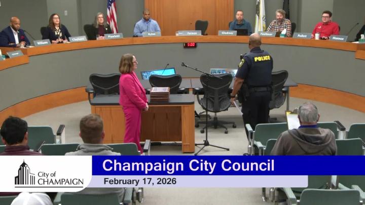Wide Shot of Council Dias. Mayor Feinen and Police Chief Tyler standing in front of Dias. 
