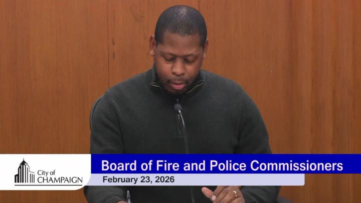 Close up of Police and Fire Board Chair presiding over the meeting. 